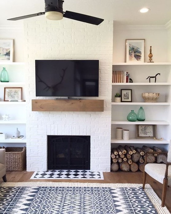 a farmhouse living room with a white brick wall and touches of wood and wicker for coziness