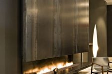 a gas fireplace clad with sleek metal is a bold statement feature for any contemporary space