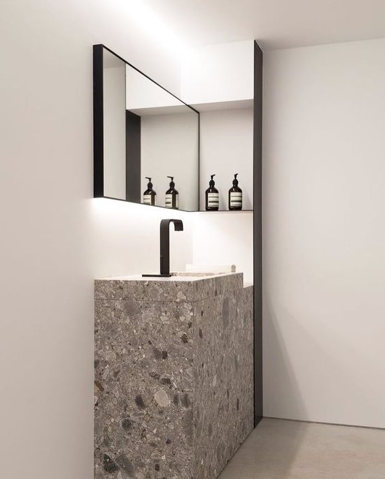 A grey and white terrazzo sink and sink stand for a minimalist bathroom with an eye catchy look