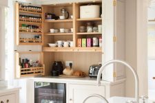 a large built-in pantry with open shelves, shelves on the door, some appliances, tableware and jars is a cool solution