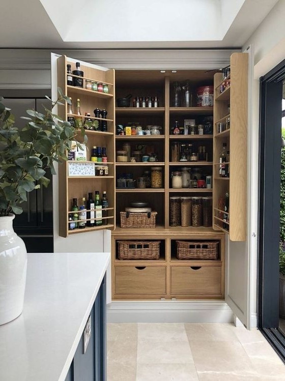 a large built-in pantry with stained shelves, drawers and baskets feels and looks rustic and very elegant