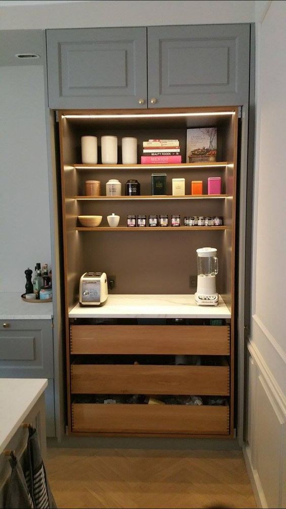 a minimal built-in pantry with open shelves and built-in lights, drawers, various appliances, jars and cans is a cool idea