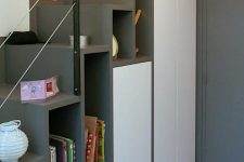 a modern grey and white staircase with open storage compartments and hidden ones is a cool and smart idea for a small home