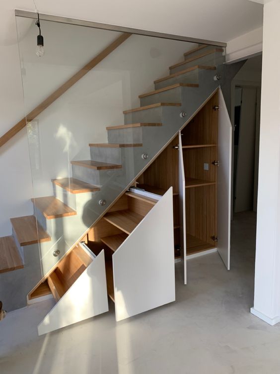a modern grey staircase with stained steps, storage compartments and drawers is a lovely idea for a modern space