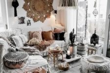 a neutral gypsy space with macrame boho pillows rugs and ottomans a fringe lamp and boho lamps
