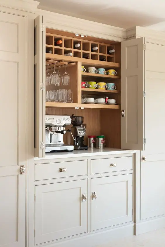 a small and smart built-in pantry with open shelves, wine storage, a coffee machine and some other stuff hides the clutter away