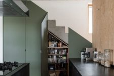 a tiny kitchen under stairs