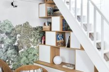 a staircase with a Scandinavian storage unit built in, with open and closed storage compartments, books and decor