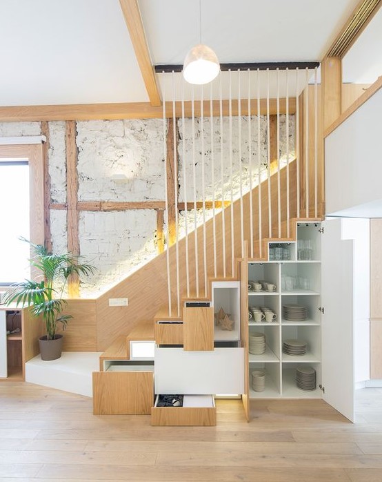 A staircase with built in drawers and cabinets is a smart and cool idea for a modern space, it can be a nice solution