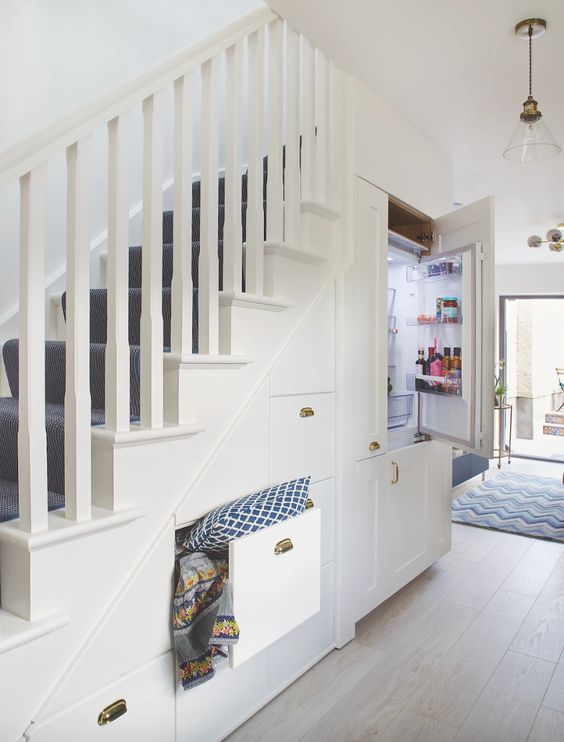 A staircase with built in drawers and even a fridge to make it seamless and to save some floor space in the kitchen