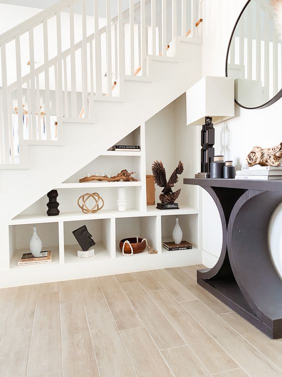 A staircase with built in open storage compartments that are used for displaying and decorating is a very chic solution