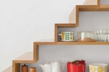a staircase with built-in open storage compartments that are used for storage and display is a smart idea for a kitchen