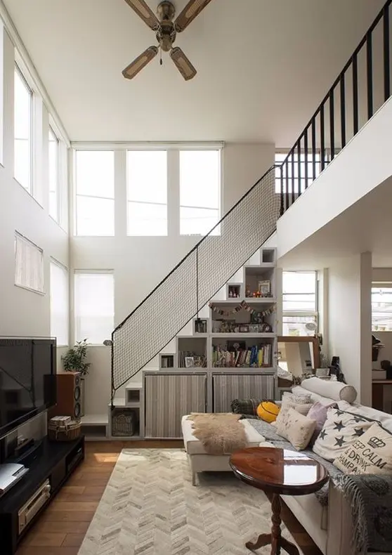 a staircase with shelves and large fabric cubbies is a smart way to store some things