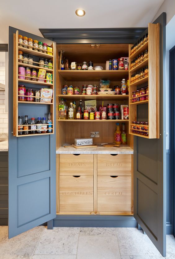 a stylish and comfortable pantry with stained shelves, shelves on the doors, drawers with labels what's inside and lots of  food