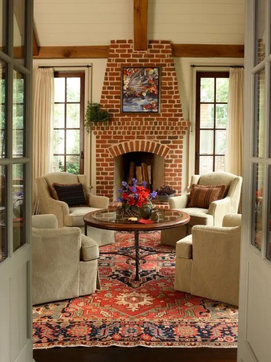 a traditional living room done with a fireplace of red brick for maximal coziness and a vintage feel