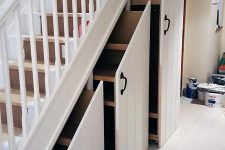 a white staircase with large drawers with planked panels and handles is a very comfortable idea for any home