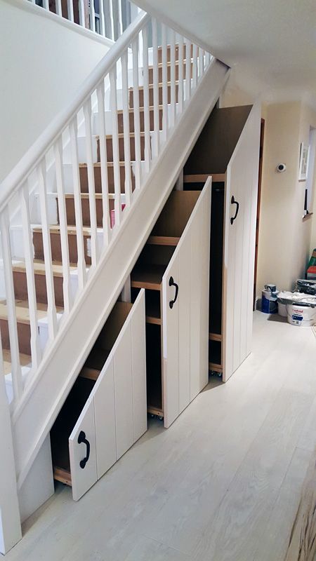 a white staircase with large drawers with planked panels and handles is a very comfortable idea for any home