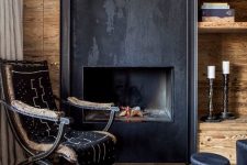 an exotic chalet living room with a metal fireplace, open shelves, a vintage and black side tables looks unique