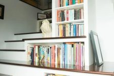 bookshelves built-in right into the staircase to use every inch of space are a smart solution for anyone