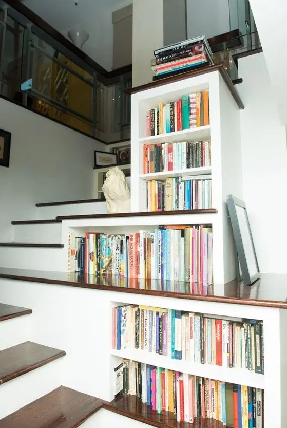 bookshelves built-in right into the staircase to use every inch of space are a smart solution for anyone
