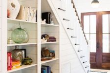 built-in open shelves under the stairs are nice to get more storage space without sacrificing floor space