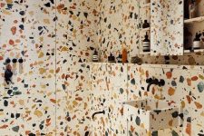 colorful spotted terrazzo that covers the walls, the floor and even shelves will make your bathroom very bright