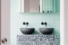 green tiles and a terrazzo sink stand in grey, black and white for an eye-catchy touch