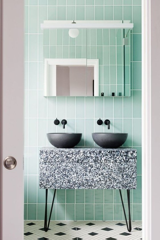 Green tiles and a terrazzo sink stand in grey, black and white for an eye catchy touch