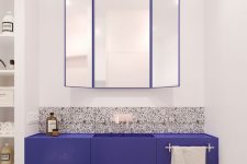 grey, black and white terrazzo on the floor and partly on the wall plus an ultra-violet vanity