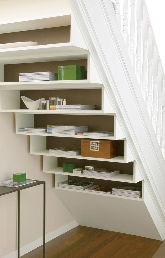 Shelves built into the staircase itself and some additional coffee tables are a non typical solution