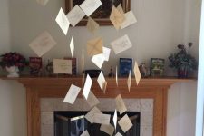 simple Harry Potter Halloween decor with letters from Hogwarts floating in the air is a cool idea for both a kids’ and adults’ party