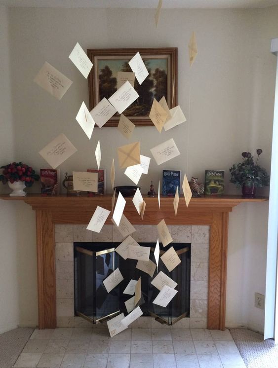 simple Harry Potter Halloween decor with letters from Hogwarts floating in the air is a cool idea for both a kids' and adults' party