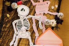skeleton-shaped invitations in pink andorange envelopes will be afun and cool idea for both a kids’ and adults’ party