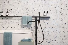 white, blue and purple terrazzo plus a free-standing bathtub and some clean lines for an ultra-modern look in the bathroom