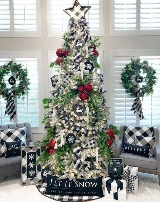 a Christmas tree decorated with buffalo check stars, buffalo check pillows, artworks and ribbons for a stylish vintage look