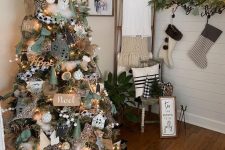 a Christmas tree with houses, gift boxes, greenery, a star topper, lights and burlap ribbon, some plaid touches plus white ornaments is a cool idea
