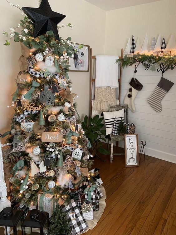 a Christmas tree with houses, gift boxes, greenery, a star topper, lights and burlap ribbon, some plaid touches plus white ornaments is a cool idea