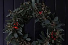 a beautiful modern Christmas wreath of evergreens, eucalyptus and berries is a stylish and timeless solution