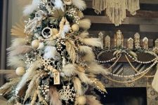 a bold boho Christmas tree decorated with pampas grass, neutral ornaments, owl ornaments and wooden beads is a super cool idea