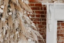 a creative boho Christmas tree of pampas grass and snowy branches, petals and ribbons and matching mantel decor