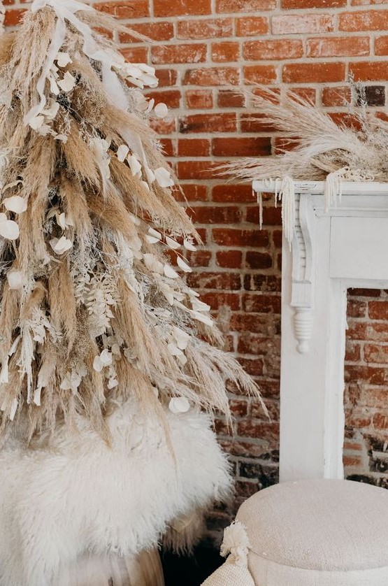 a creative boho Christmas tree of pampas grass and snowy branches, petals and ribbons and matching mantel decor