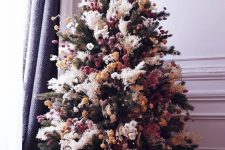 a creative boho Christmas tree with pampas grass, dried blooms and pompoms is a cool and bold solution