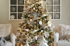 a farmhouse Christmas tree with lights, polka dot ribbons, pinecones and snowflakes is a lovely idea  for a farmhouse space