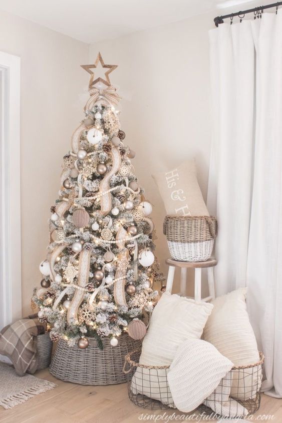 a farmhouse Christmas tree with wooden beads, burlap ribbons, white and fabric ornaments, and a star topper