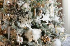 a farmhouse flocked Christmas tree with snowflakes, calligraphy, mini sheep, lights, ornaments and other stuff