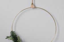 a minimalist Christmas wreath with evergreens, foliage, berries and pinecones is a stylish decor idea for a minimalist home