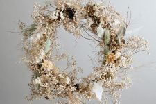 a modern ethereal Christmas wreath with dried blooms, grasses, berries and some leaves is a cool and catchy idea