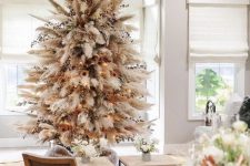 a neutral boho Christmas tree made of pampas grass, dried blooms and leaves, lights and sunflowers is a lovely idea