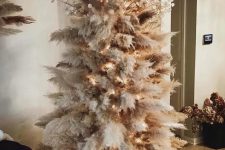 a pampas grass Christmas tree decorated with lights and lunaria is a cool and chic idea for a boho space