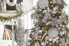 a rustic Christmas tree with pinecones, whitewashed signs, mini churches, pinecones, snowflakes and lights is amazing